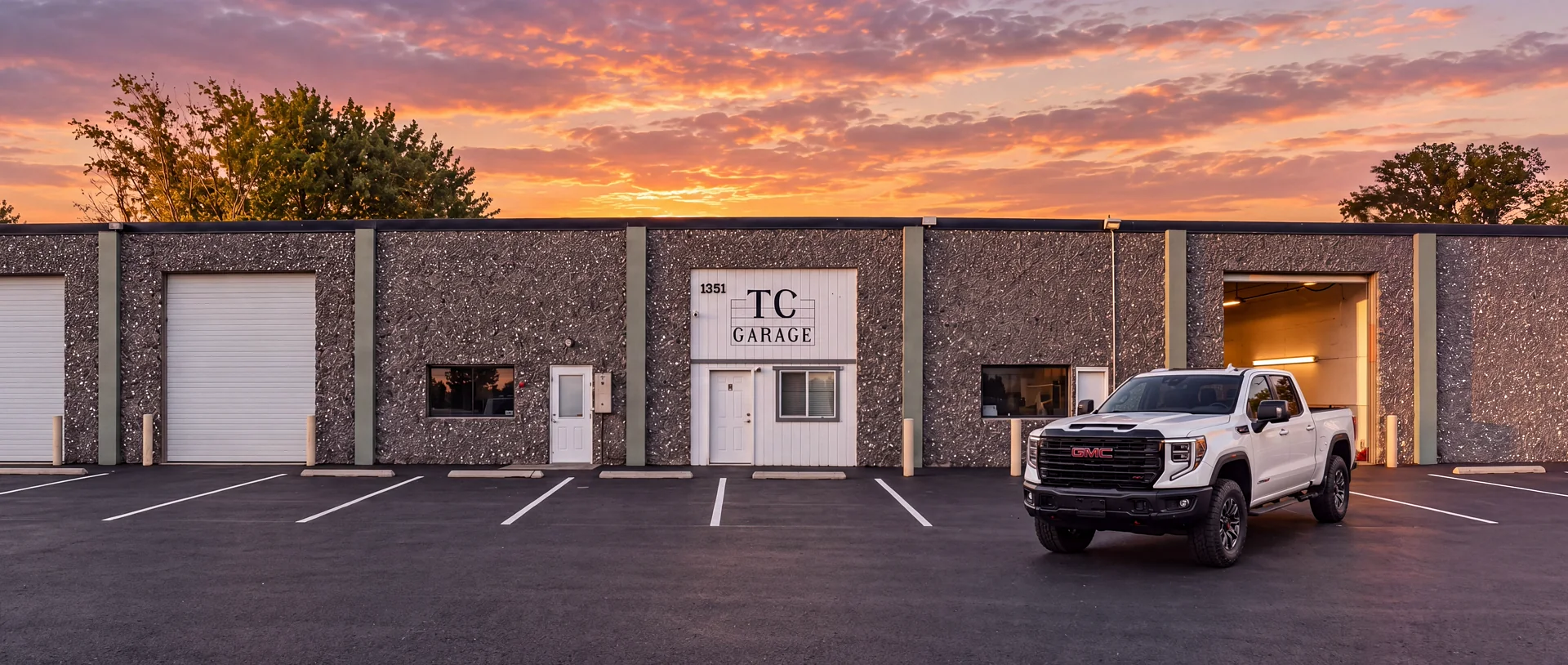 A white GMC pickup parked in front of TC Garage at 1351 E 3rd Ave, Kennewick, at sunset